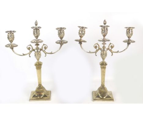 A pair of late 19th/early 20th century electroplated two branch candelabra with three ornamental urn shaped sconces and folia