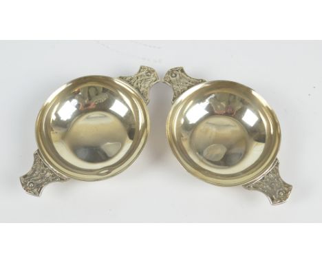 WAKELY & WHEELER; a pair of George VI hallmarked silver quaiches with cast Celtic motif decorated handles, London 1943, lengt