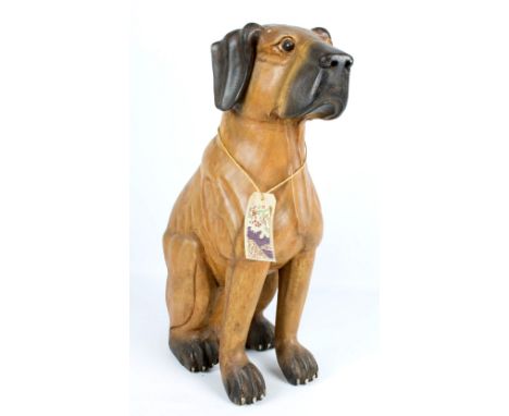 A carved wooden life sized model of a seated dog, height 61cm. CONDITION REPORT: The item is modern, possibly made in the Mid