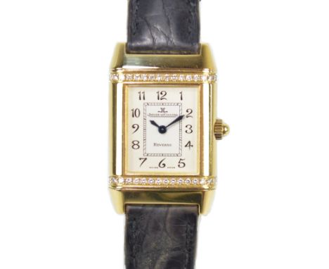 JAEGER-LECOULTRE; a lady's 18ct yellow gold and diamond set Reverso wristwatch with square silvered dial set with Arabic nume
