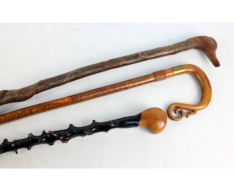 Two shepherds' staffs including one with handle modelled as duck's head and a lacquered gnarled walking stick (3).