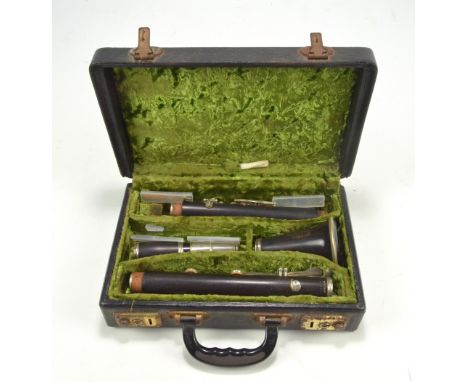 A cased Boosey & Hawkes of London ebonised series 2-20 clarinet, number 205630.