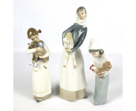 Three Lladro figures comprising two girls holding a lamb (one af), and a girl holding a cockerel (3). CONDITION REPORT: The s