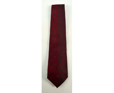 GIANNI VERSACE; a silk burgundy textured tie.
