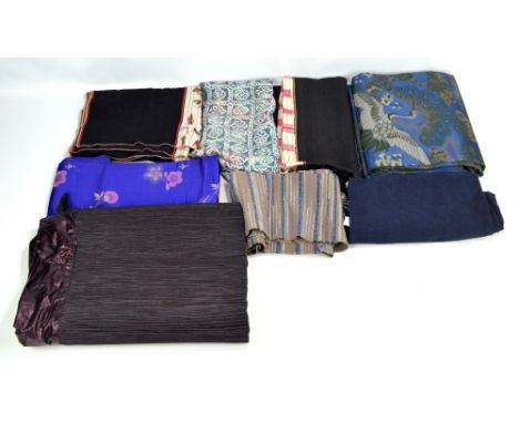 A quantity of Japanese textiles including a furoshaki, a sakiori obi, a rinzu silk shibori panel, etc.