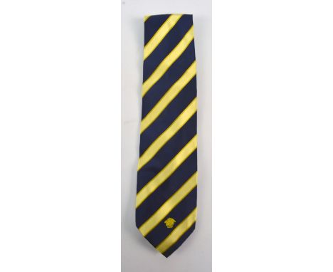 GIANNI VERSACE; a silk tie decorated with yellow and navy blue diagonal stripes.