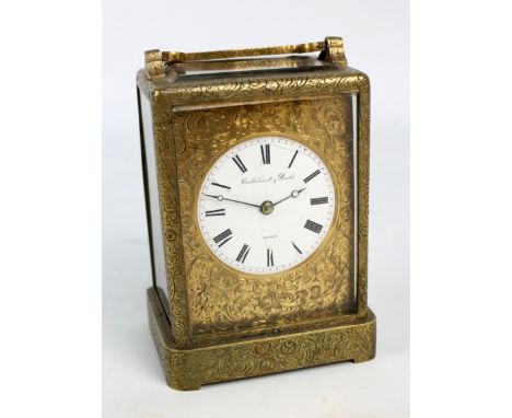 A 19th century French brass cased carriage clock, the rectangular gilt metal foliate scroll engraved face set with circular e
