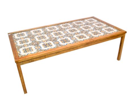 A rectangular tile top coffee table, length 130.5cm.