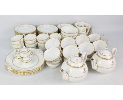 A Royal Crown Derby white gilt heightened porcelain tea set comprising a pair of teapots, a hot water pot, four spare lids, s