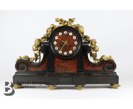 19th century French slate and boulle mantel clock, having a boulle face with porcelain Roman dial, flanked by two scroll plat