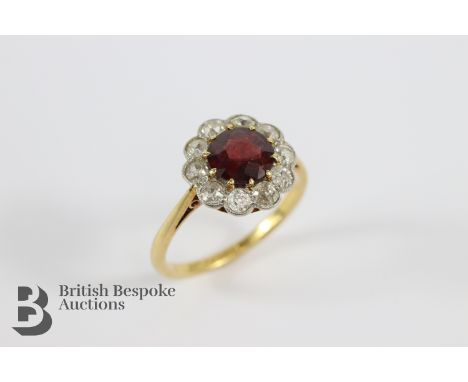 18ct yellow gold and platinum ruby and old-cut diamond and white sapphire cluster ring. The central stone measures 6.6mm and 