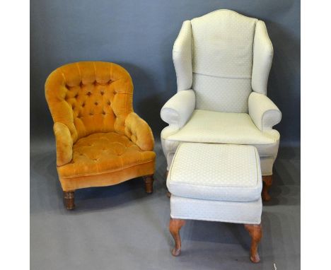 A Queen Anne Style Wingback Armchair with matching stool together with a Victorian button upholstered low seat nursing chair 