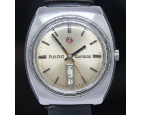 A vintage stainless steel Rado Conway automatic wristwatch with signed champagne dial, red center sweeping seconds and day/da