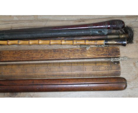 A bundle of sticks comprising a military pacing stick, a Canadian swagger cane, gun cleaning rods etc.  