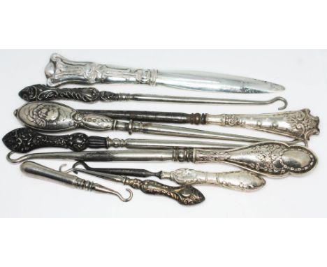 Eight hallmarked silver handled button hooks and an Art Nouveau letter opener.  