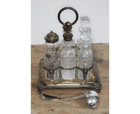 A six bottle silver plated cruet and a silver plated ladle.  