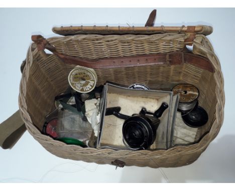 A vintage wicker creel with contents to include a fishing line dryer and Duco reel etc. 