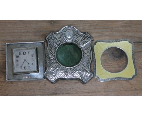 Assorted hallmarked silver comprising a watch holder, an Art Deco clock and an enamel frame.  