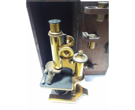 An R. &amp; J.Beck Ltd of London microscope with wooden case and 4 brass containers, serial number 23981. 