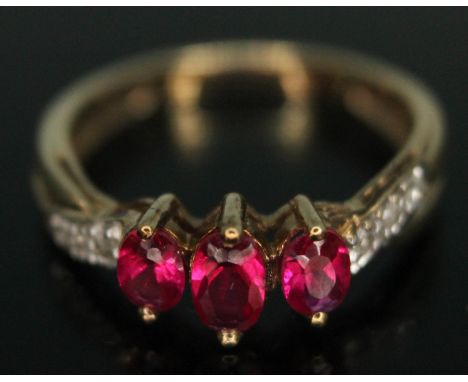 A synthetic ruby and diamond ring, marked '9ct', gross wt. 1.73g, size J.  