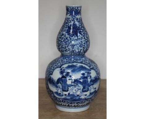 A Chinese blue and white double gourd vase, bearing six character Kangxi mark to base, 20th century, height 20cm.Condition: n