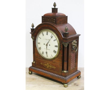 A Regency brass inlaid mahogany bracket clock, domed top with brass finials, corinthian brass mounted fluted columns, the 9" 