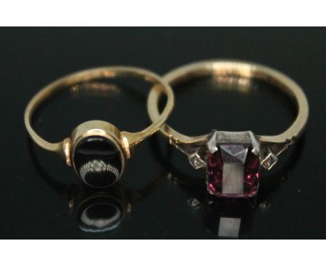 A hallmarked 9ct gold signet ring set with black onyx and a ring set with purple past marked '9ct', gross wt. 3.89g, size Q &