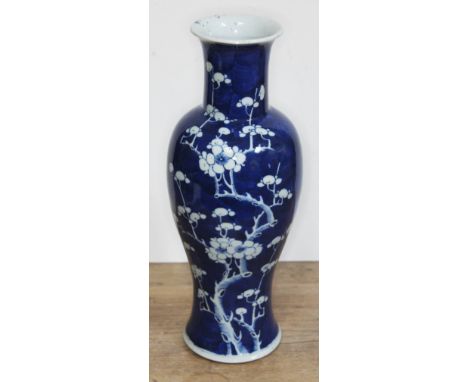 A Chinese blue and white vase decorated with flowering prunus, Kangxi double circle to base, height 35cm.Condition: minor wea