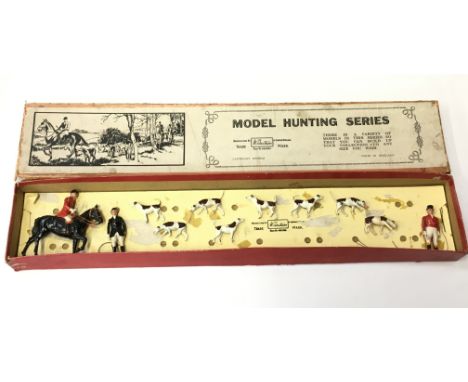 Britains Model Hunting Series No.1446 Set, comprising: Mounted Huntsman; Standing Huntswoman; Standing Huntsman; 8 x Hounds. 