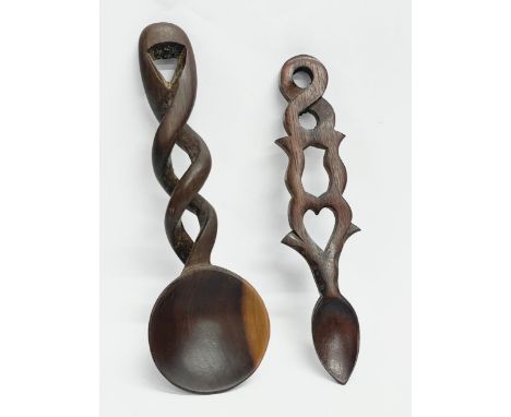 A vintage Welsh Love Spoon and a carved wooden serving spoon. 