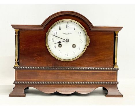 A late Edwardian inlaid mahogany mantle clock with brass mounts, key and pendulum. Riddles Limited, Belfast. 31x12x24cm 