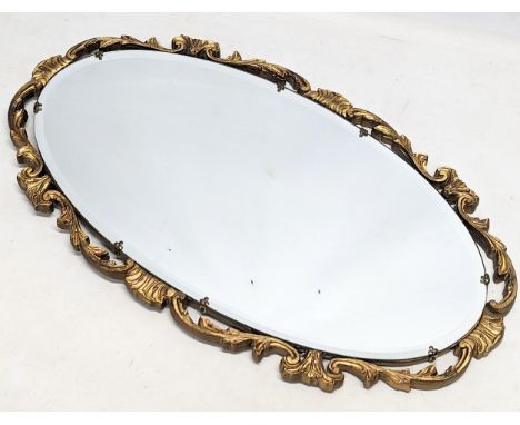A vintage ornate gilt framed bevelled mirror. 66.5x 38.5cm 