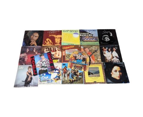 A collection of vintage vinyl records including Bob Marley, Slade, etc. With a collection of annuals. 