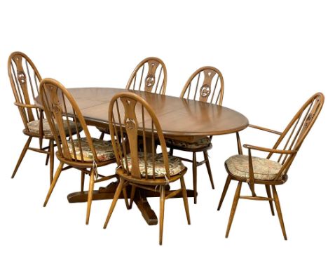 An Ercol Mid Century elm extending dining table and 6 chairs.  165x116x74cm 