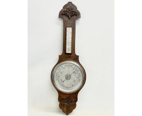 A late Victorian oak Aneroid barometer. 82cm 