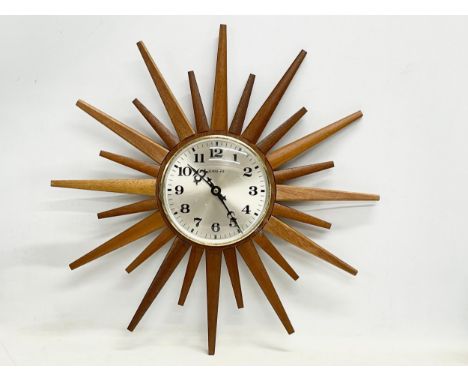 A Mid Century teak ‘Sunburst’ wall clock by Eurastyle. 48cm 