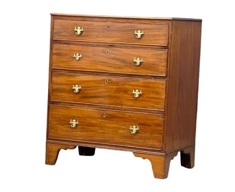 A fine proportioned mid 19th century Georgian style mahogany chest if drawers with original brass drop handles on bracket fee