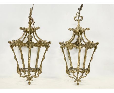 A pair of vintage ornate brass ceiling light fittings. 91cm including chain. Frames measure 23x43cm 