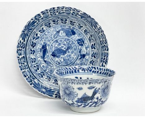 A 19th century Chinese porcelain tea bowl and saucer. Kangxi mark. 