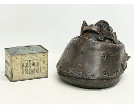 A Victorian leather lawn shoe and a vintage tin, The Queen’s Dolls’ House issued by Cauldon Potteries LTD. Chubb &amp; Son’s 