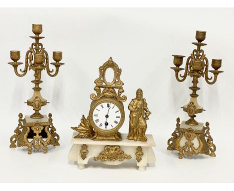 A late 19th century French brass and onyx clock set. Clock measures 25x10x31cm. Candelabras 38.5cm. 
