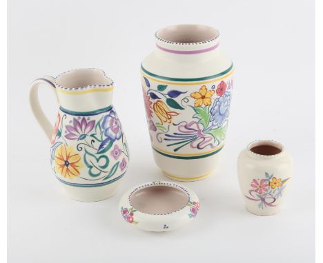 Two Poole pottery vases 23cm high and 10cm high, jug 18.5cm high, and dish 11.5cm diameter, all decorated with flowers, (4),