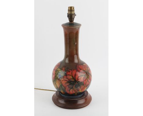 Moorcroft clematis pattern lamp on integral wooden base, 41cm high,