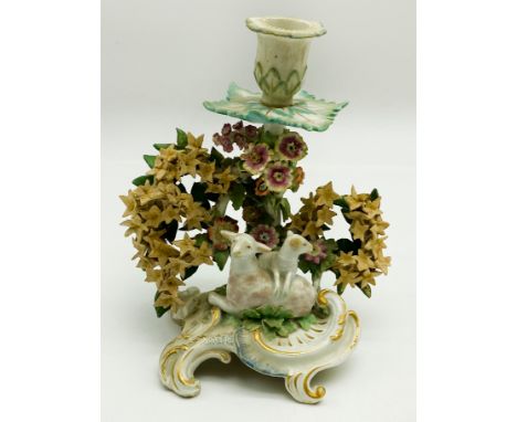 AN EIGHTEENTH-CENTURY ENGLISH PORCELAIN CANDLESTICK WITH FINELY EXECUTED BOCAGE AND A WELL-RENDERED MODELLING OF A EWE AND HE