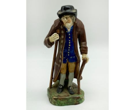A STAFFORDSHIRE CERAMIC FIGURE OF AN ELDERLY MAN DEPICTING "AGE" WEARING A BROWN GLAZED COAT AND SUPPORTED ON CRUTCHES.THE UN