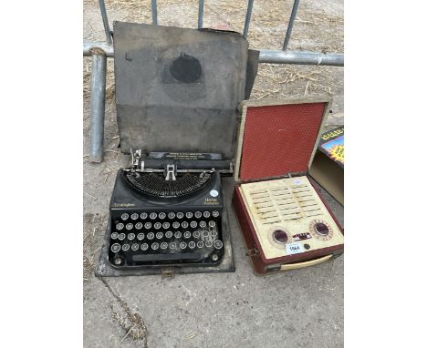 A VINTAGE REMINGTON TYPEWRITER WITH CARRY CASE AND A RETRO RADIO 