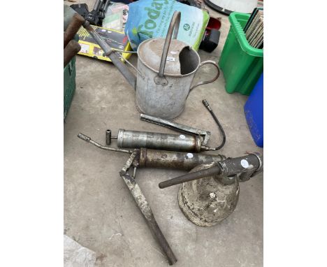 AN ASSORTMENT OF TOOLS TO INCLUDE A GALVANISED WATERING CAN AND TWO GREASE GUNS ETC 