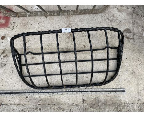 A METAL WALL HANGING HAYRACK PLANTER 