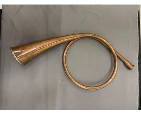 A COPPER, COILED HUNTING HORN 