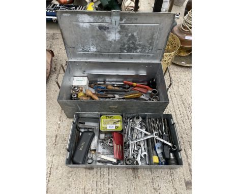 A METAL TOOL BOX WITH AN ASSORTMENT OF TOOLS TO INCLUDE SPANNERS, DRILL BITS AND PLIERS ETC 